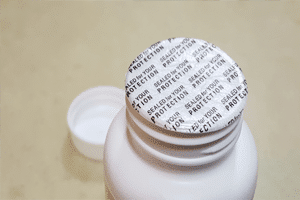 protective-sealed-on-top-of-white-plastic-bottle-for-protection protective-sealed-on-top-of-white-plastic-bottle-for-protection